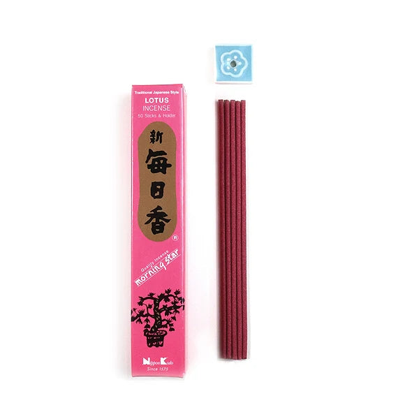 A pink box of Morning Star Lotus Incense features black text and a floral design. Red incense sticks and a small blue ceramic holder with a white floral pattern complement the setup, creating a relaxing ambiance inspired by classic Japanese traditions.
