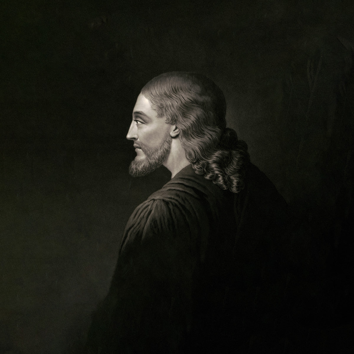 The Authentic Image of Jesus Museum-grade Print features a monochrome profile of Jesus of Nazareth, showcasing his long, wavy hair and beard. His serene expression is highlighted against a dark background, capturing timeless reverence with his robes soft texture.