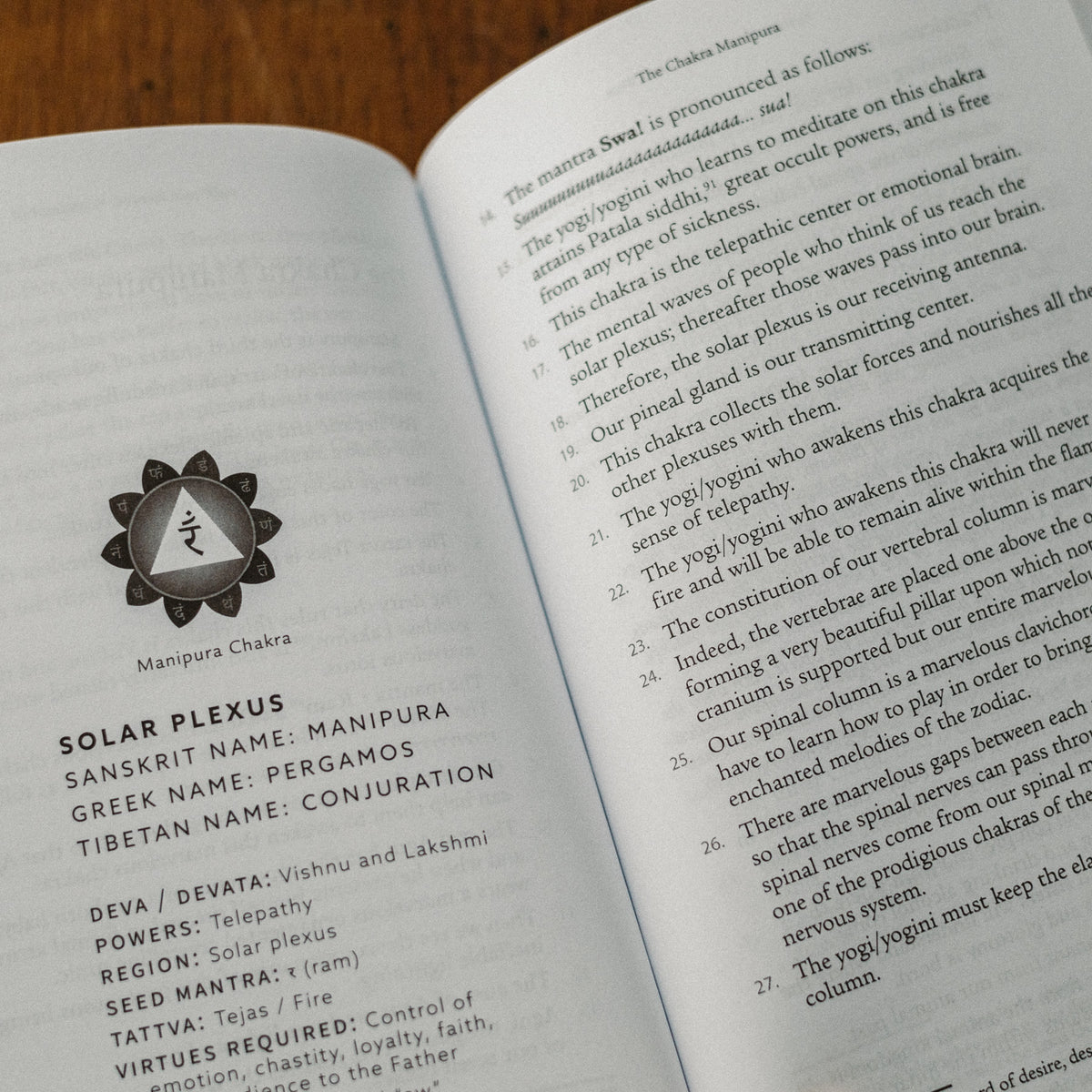 An open book, Kundalini: The Sacred Fire of All Religions, details the solar plexus chakra (Manipura), showcasing its symbol and exploring its links to Kundalini and spirituality, including associated powers, deities, and virtues.