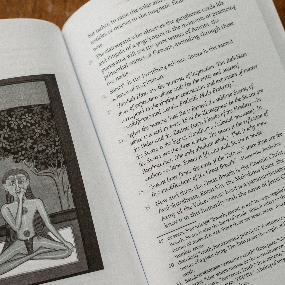 A book page open to text featuring a drawing of a person meditating under a detailed tree, exploring Kundalini and the science of breathing, linking spirituality and divine power. Product: Kundalini: The Sacred Fire of All Religions.