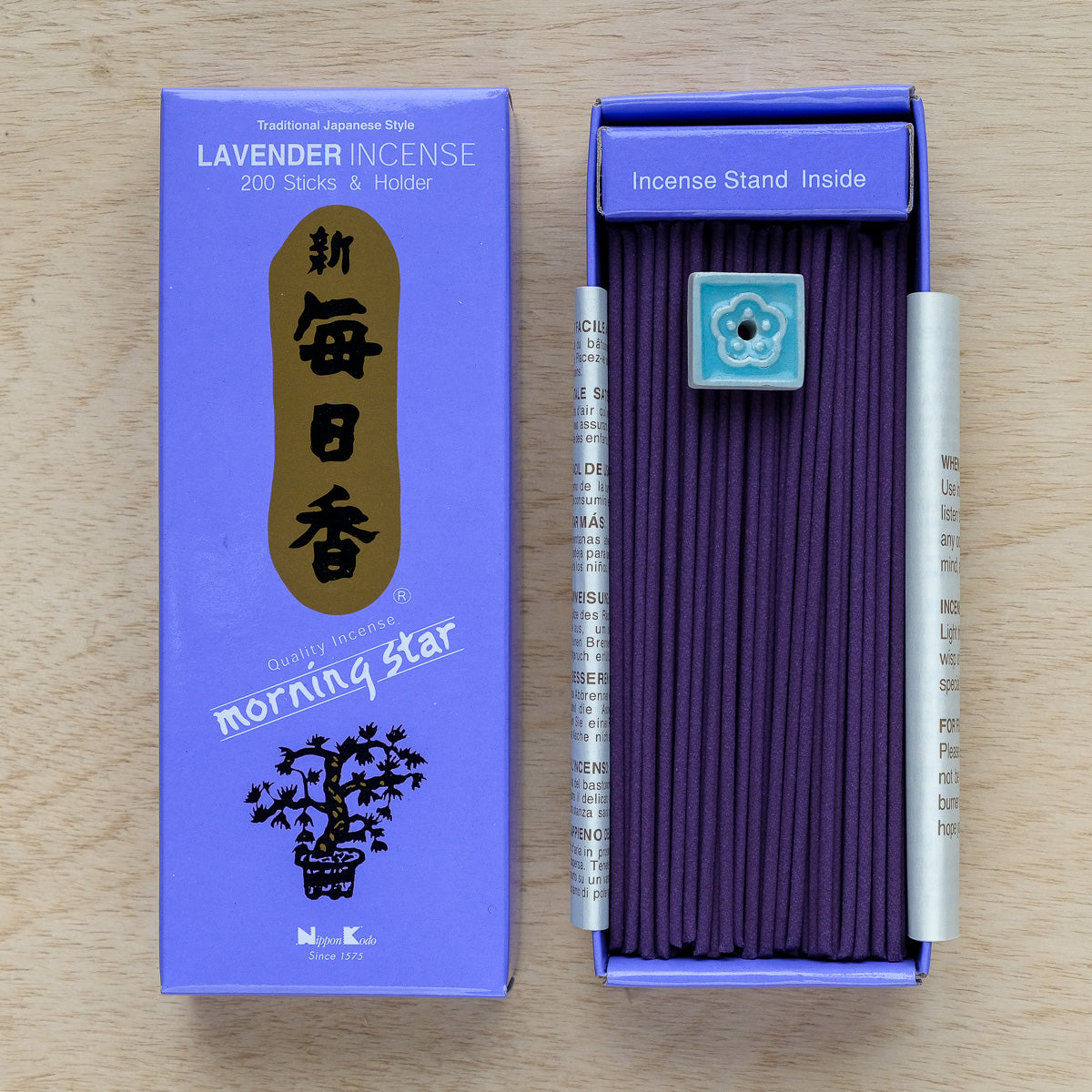 A box of Morning Star Lavender Incense reveals elegant purple sticks and a small holder, all embodying Japanese style. The purple box, accented in gold and blue, states: Lavender Incense, 200 Sticks & Holder.