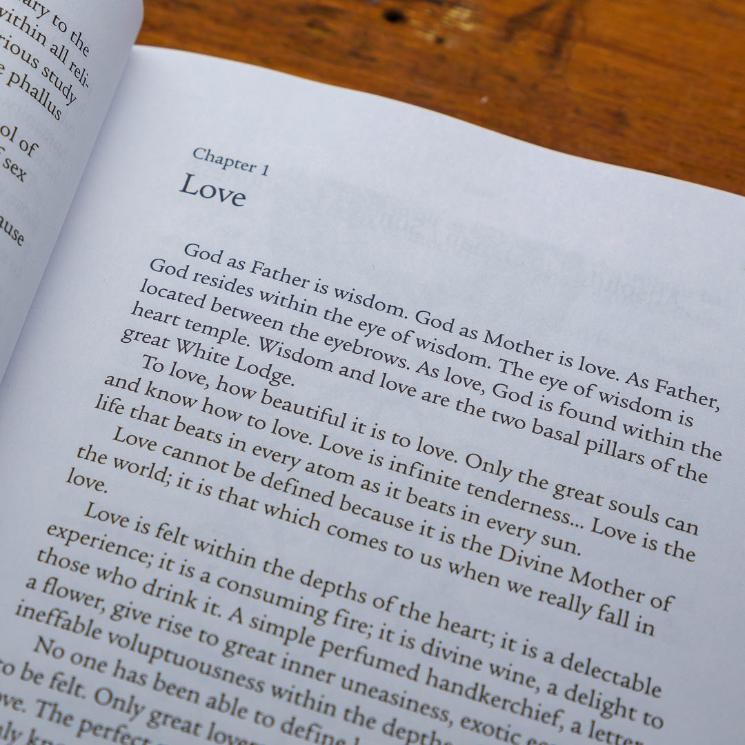 Opening to Chapter 1, titled Love, the book Perfect Matrimony delves into themes of wisdom, love, and divinity, portraying God as both Father and Mother. It delicately addresses the Perfect Matrimony and forbidden fruit while resting on a wooden surface.