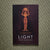 Book cover of 'Light from Darkness' on a textured green surface