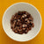 White bowl filled with sandalwood resin incense on a yellow background
