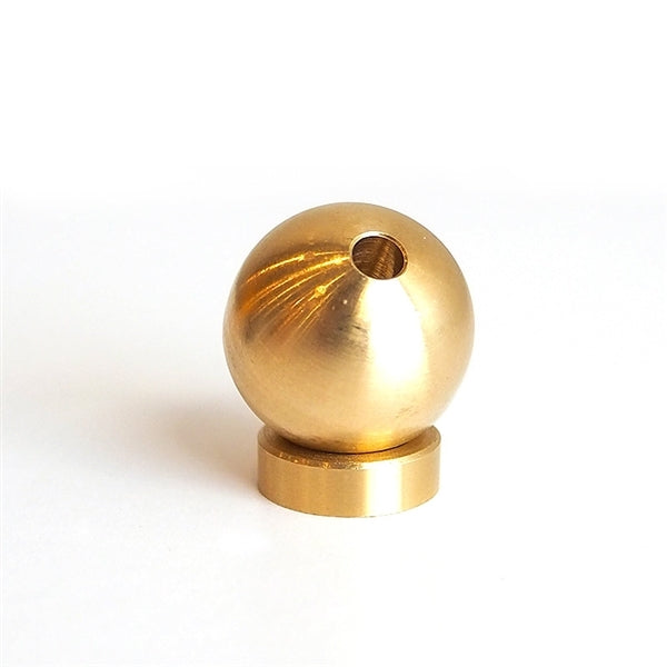 The Sphere Incense Holder features a polished brass finish with a spherical design and a hole on top. It rests elegantly on a flat circular base, its reflective surface creating a shiny appearance against the plain white background.