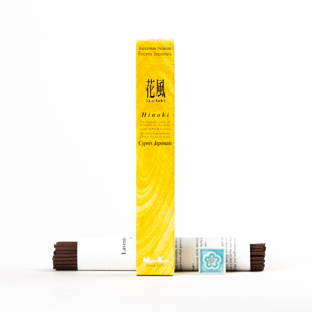Against a white backdrop, the Ka-Fuh Hinoki (Japanese Cypress) Incense package emits a pure aroma. Two bundles of incense sticks wrapped in white bands rest in front, with the predominantly yellow packaging showcasing a subtle texture.