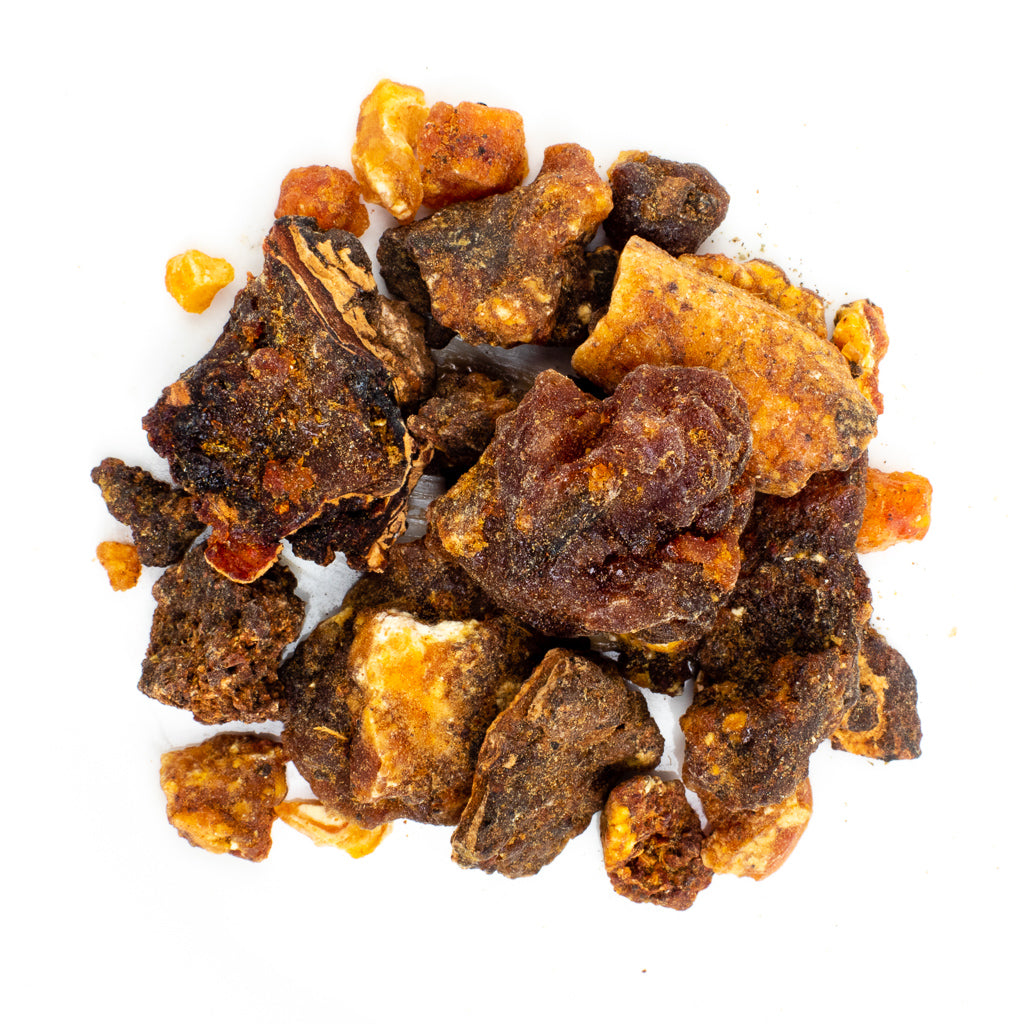 First Grade Opoponax (Sweet Myrrh) Resin Incense features irregularly shaped chunks intertwined with myrrh, showcasing shades of amber, brown, and dark ochre with a rough texture against a plain white background.