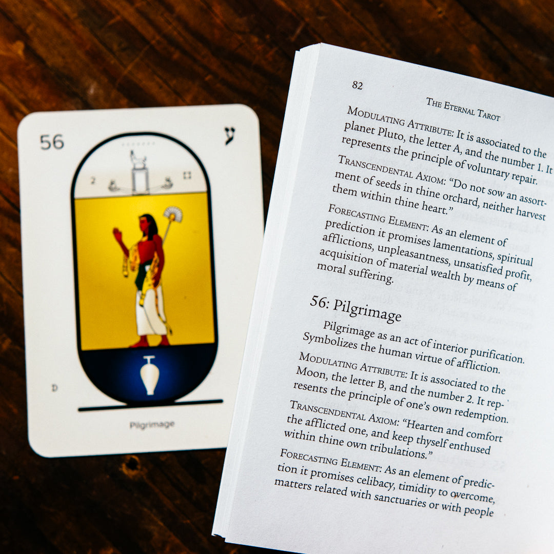 An open Eternal Tarot Deck and Book Set lies next to a card depicting an Egyptian figure with an ankh and staff, marked with the number 56 and Hebrew letter Yod, hinting at Metatrons celestial secrets.