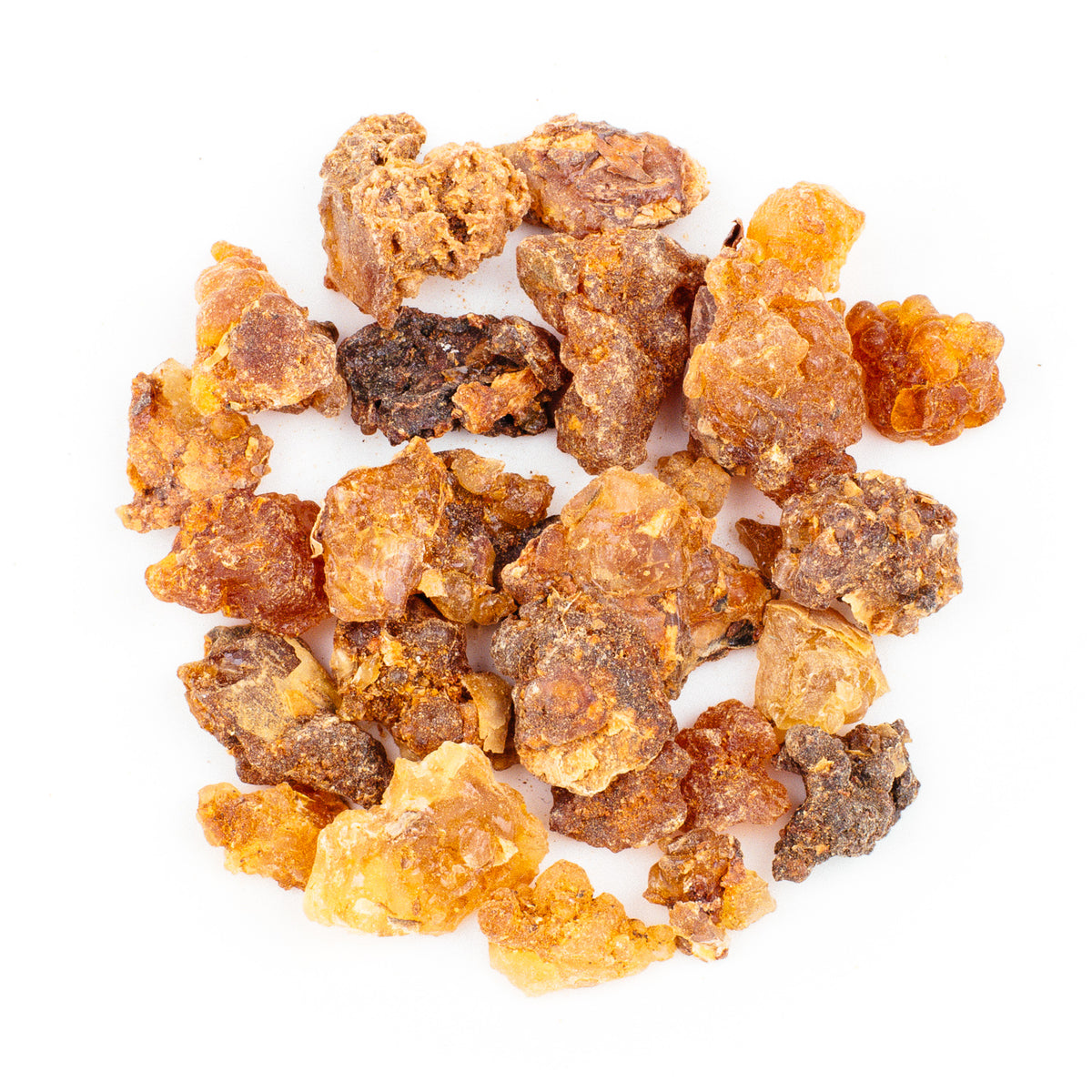 Myrrh Resin Incense, Common Grade: A variety of amber, brown, and yellow commiphora-derived incense pieces with rough textures scattered on a white background.