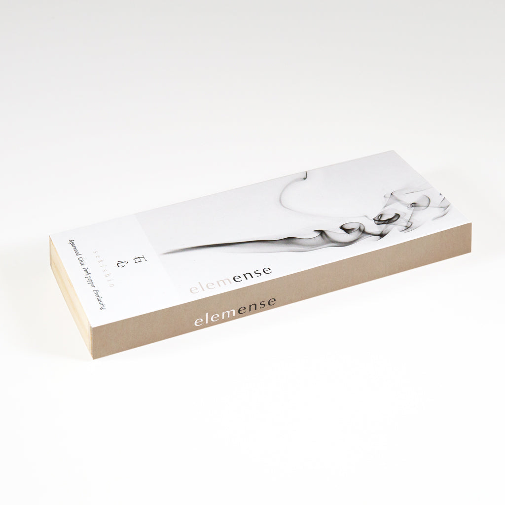 The Elemense Sekishin Japanese Incense comes in a minimalistic rectangular box adorned with abstract black and white patterns. Inside, discover Japanese paper incense sheets crafted from natural materials, embodying the serene elegance of the Five Elements Theory with its beige and white design.
