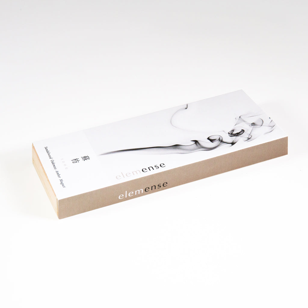 A rectangular box of Elemense Suou Japanese Incense features a minimalist design with black, smoke-like art on a white background. Made from natural aromatic materials, the brand name elemense appears on the side in lowercase, inspired by Five Elements Theory.